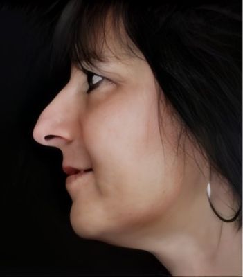 Profile view of a woman against a dark background.