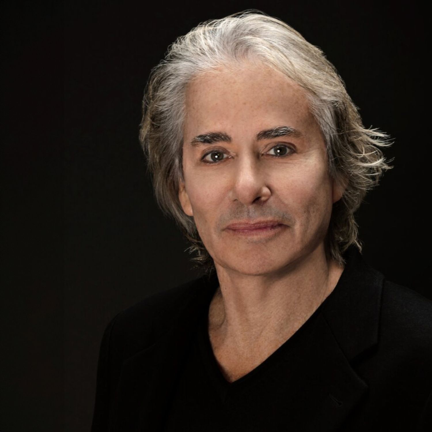 Portrait of a man with gray hair.