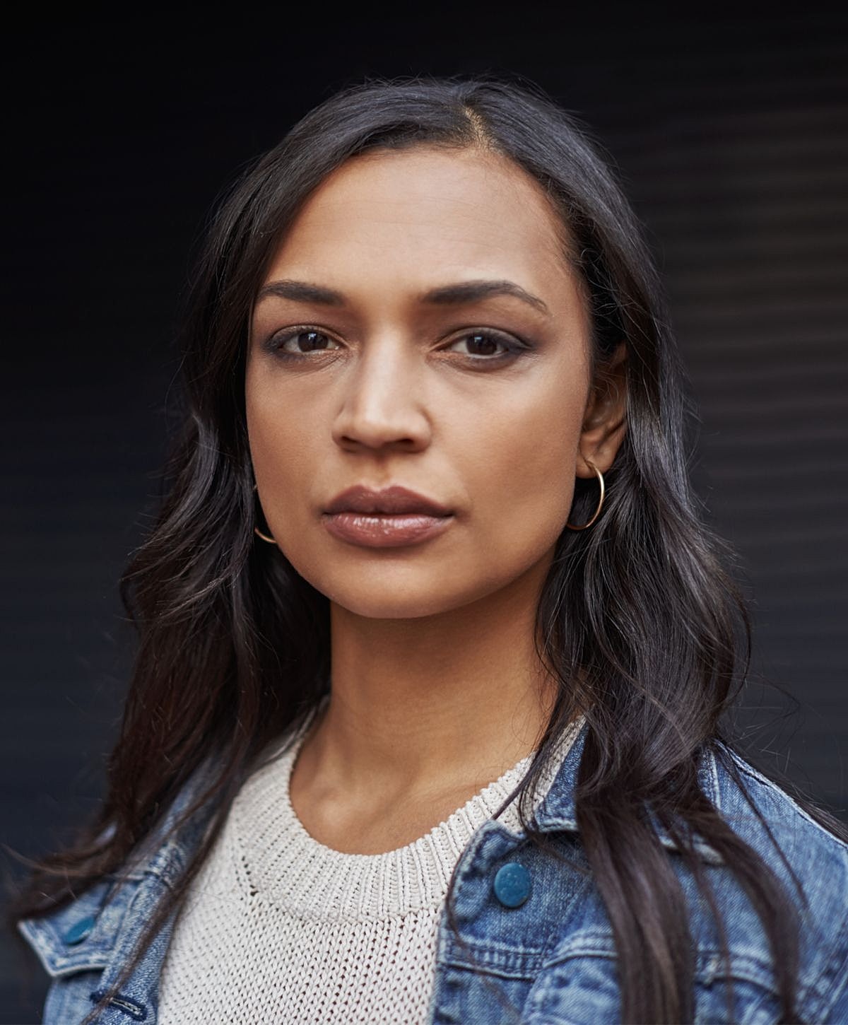 Portrait of a woman with long dark hair.