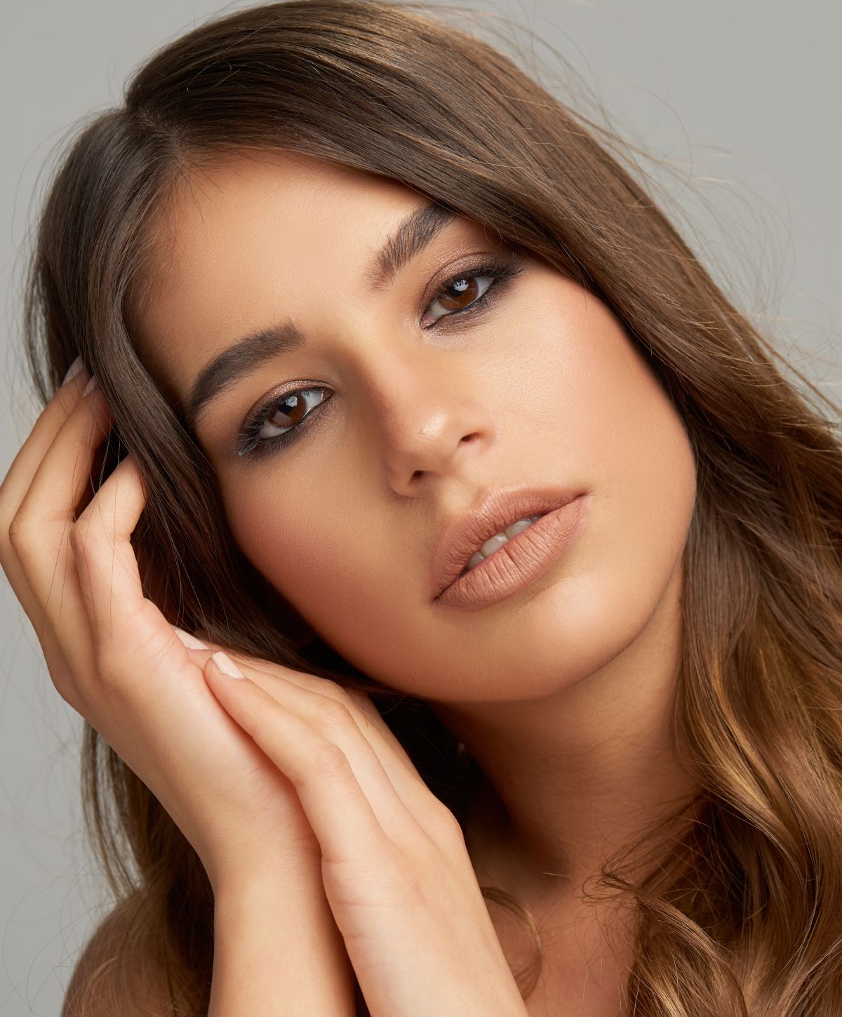 Woman with long hair and soft makeup.