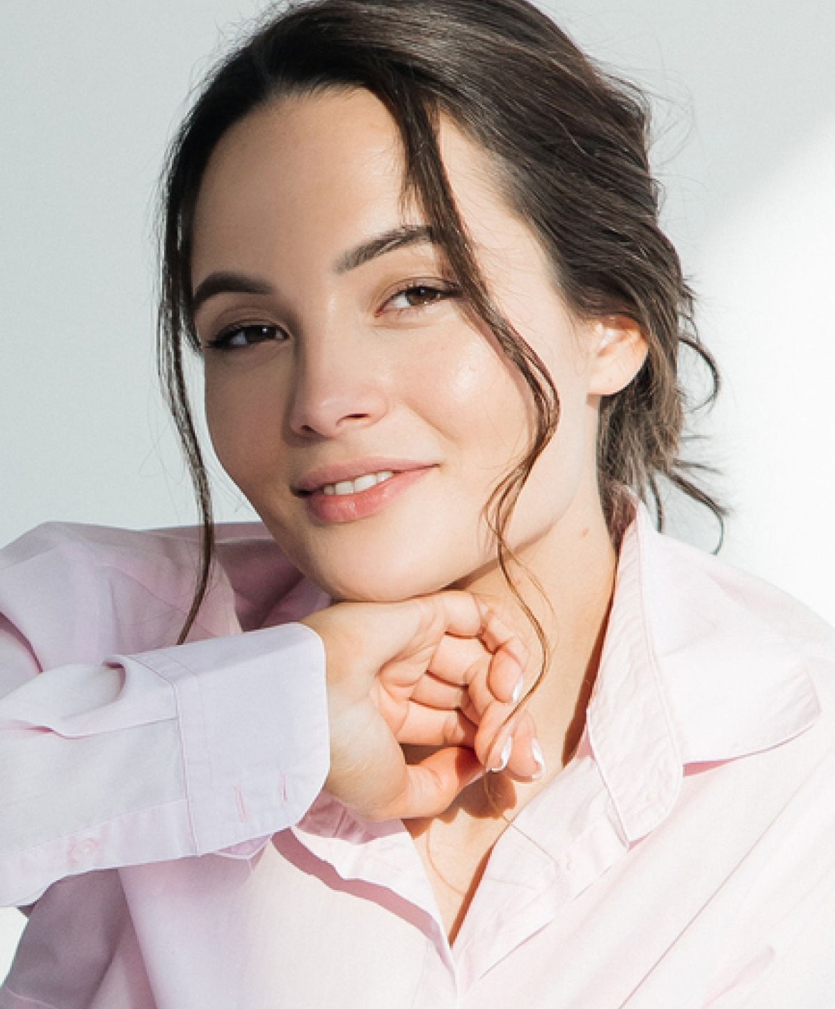 Smiling person in a light pink shirt.