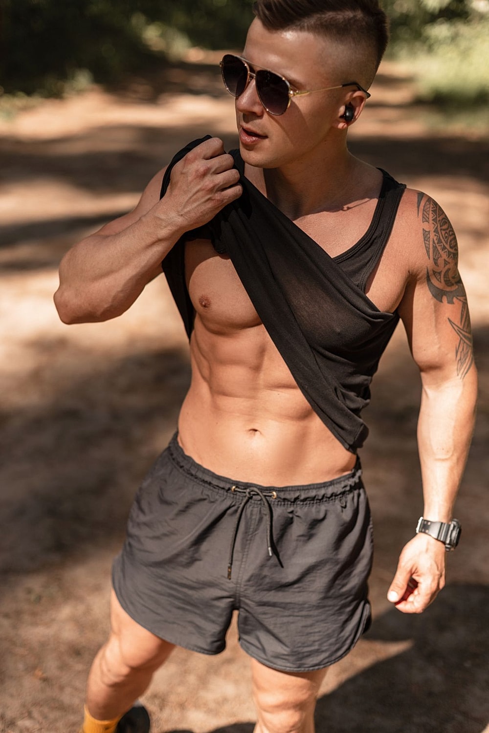 Man adjusting shirt in casual outdoor setting