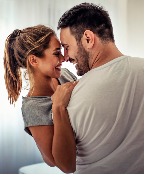 Couple sharing a joyful moment indoors.