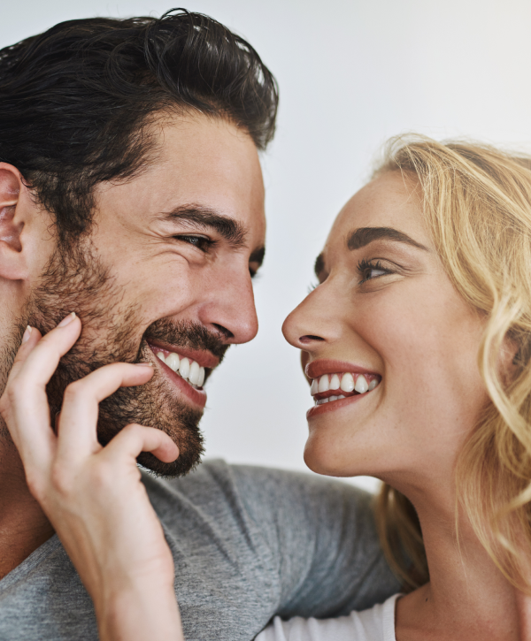 Smiling couple sharing an intimate moment.